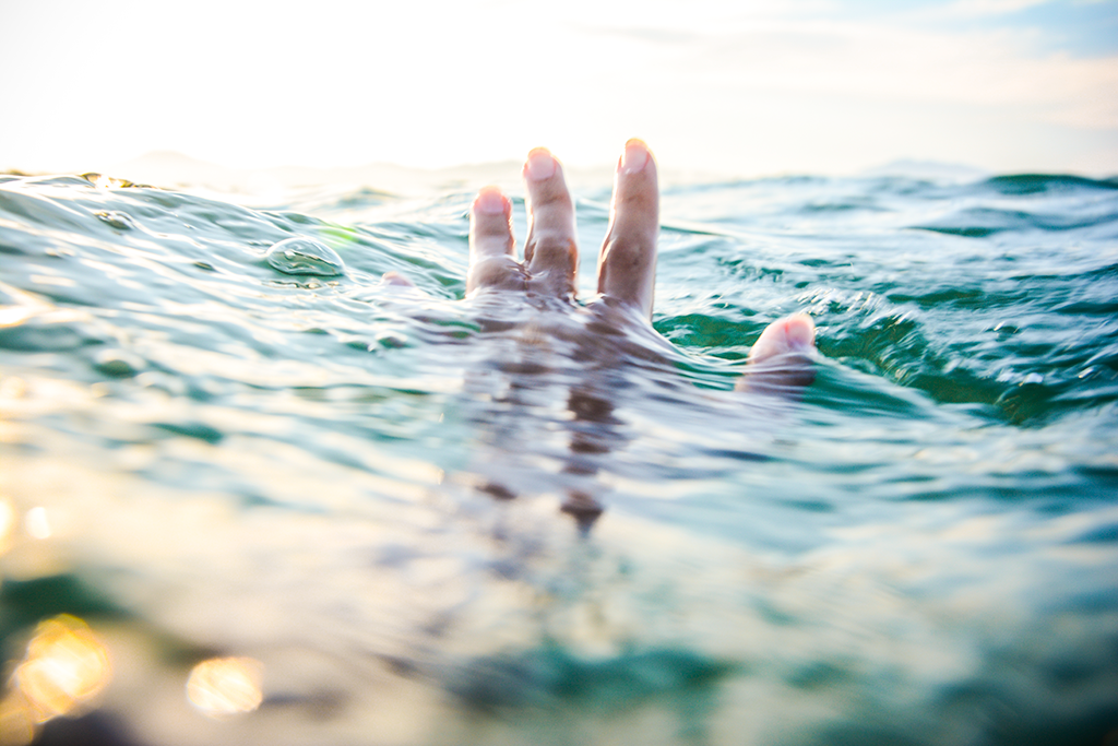 Hand emerging from the water, representing hope